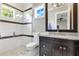 Stylish bathroom features a walk-in shower with glass doors and dark wood vanity with granite countertop at 10845 Bayshore Dr, Windermere, FL 34786