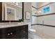 Modern bathroom featuring a glass-enclosed shower and granite countertop at 10845 Bayshore Dr, Windermere, FL 34786