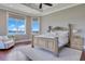 Spacious bedroom with lake views, tray ceiling, and natural light, creating a relaxing atmosphere at 10845 Bayshore Dr, Windermere, FL 34786