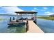 A covered boat lift stands ready on the lake, offering a convenient and protected space for watercraft at 10845 Bayshore Dr, Windermere, FL 34786
