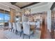 Elegant dining room boasts hardwood floors, designer lighting, and a serene water view at 10845 Bayshore Dr, Windermere, FL 34786