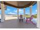 Relax and enjoy lake views from the covered dock, furnished with comfortable seating and a small table at 10845 Bayshore Dr, Windermere, FL 34786