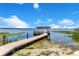 Lakefront home featuring a private dock with a covered boat lift, providing direct access to the serene waters at 10845 Bayshore Dr, Windermere, FL 34786