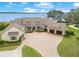 Elegant home featuring a circular driveway, well-manicured lawn, and a charming front porch with welcoming chairs at 10845 Bayshore Dr, Windermere, FL 34786