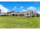 The backyard features covered patio and manicured landscaping at 10845 Bayshore Dr, Windermere, FL 34786