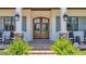 Elegant double front door flanked by stone columns, accentuating the home's curb appeal at 10845 Bayshore Dr, Windermere, FL 34786