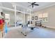 Bright gym with rowing machine, dumbbell rack, and large mirrors at 10845 Bayshore Dr, Windermere, FL 34786