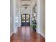 Elegant hallway with dark wood floors, statement lighting, and classic decor at 10845 Bayshore Dr, Windermere, FL 34786