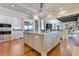Spacious kitchen with oversized island, stainless appliances, custom cabinets, wood floors, and granite counters at 10845 Bayshore Dr, Windermere, FL 34786