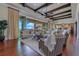 Open-concept living room featuring exposed beams, comfortable seating, and a seamless connection to the outdoors at 10845 Bayshore Dr, Windermere, FL 34786