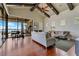Open concept living room with wood floors, vaulted ceilings with beams, and gorgeous water view at 10845 Bayshore Dr, Windermere, FL 34786