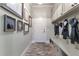 Functional mudroom with brick floors, built-in bench, storage cabinets and coat hooks for organization at 10845 Bayshore Dr, Windermere, FL 34786