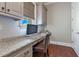 Bright office nook with granite countertop, cabinets and a window for natural light at 10845 Bayshore Dr, Windermere, FL 34786