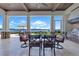 Covered outdoor patio featuring seating and a built-in kitchen with water view at 10845 Bayshore Dr, Windermere, FL 34786