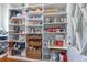 Organized pantry with white shelving and wicker baskets for ample storage of food and household items at 10845 Bayshore Dr, Windermere, FL 34786