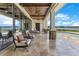 Beautiful patio features travertine floors, seating, and views of the pool and waterfront at 10845 Bayshore Dr, Windermere, FL 34786