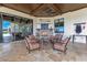 Inviting covered patio featuring a brick fireplace, comfortable seating and water views at 10845 Bayshore Dr, Windermere, FL 34786