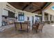 Charming outdoor patio with a cozy fireplace and scenic views of the serene lake at 10845 Bayshore Dr, Windermere, FL 34786