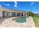 Beautiful pool with an expansive patio surrounded by a lush lawn and waterfront view at 10845 Bayshore Dr, Windermere, FL 34786