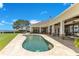 Resort-style pool with an expansive patio, outdoor seating, and serene waterfront views at 10845 Bayshore Dr, Windermere, FL 34786