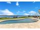 Tranquil pool and waterfront view, creating a serene outdoor oasis for relaxation and enjoyment at 10845 Bayshore Dr, Windermere, FL 34786