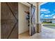 Unique sliding barn door conceals storage for water sports gear, near pool and lake at 10845 Bayshore Dr, Windermere, FL 34786