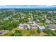 Aerial view showcasing the neighborhood, mature trees, and the home's proximity to amenities at 1115 S Mary St, Eustis, FL 32726