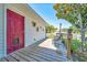 Open back porch with wooden decking, seating, and landscaping at 1115 S Mary St, Eustis, FL 32726