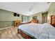Comfortable primary bedroom featuring wood floors, a ceiling fan, and decorative fireplace at 1115 S Mary St, Eustis, FL 32726