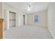 Large bedroom featuring neutral carpet, ceiling fan, and ample closet space at 1115 S Mary St, Eustis, FL 32726