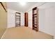 Walk-in closet with brown shelves, carpet, and white walls at 1115 S Mary St, Eustis, FL 32726