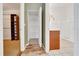 Hallway view of walk-in closet and bathroom with white and green walls at 1115 S Mary St, Eustis, FL 32726