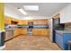 Spacious kitchen with stainless steel appliances, hardwood flooring, and a skylight for natural light at 1115 S Mary St, Eustis, FL 32726