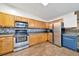 Bright kitchen with stainless steel appliances and hardwood floors, perfect for preparing meals and entertaining guests at 1115 S Mary St, Eustis, FL 32726