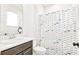 Bright bathroom features a single vanity and a shower with a fun, patterned curtain at 1147 Wildmeadow Run, Winter Park, FL 32792
