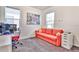 Cozy room featuring a sofa bed, an office space next to the window, and gray carpet flooring at 1147 Wildmeadow Run, Winter Park, FL 32792