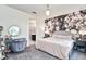 Bedroom with a floral accent wall, soft lighting, and an adjacent bathroom, creating a relaxing retreat at 1147 Wildmeadow Run, Winter Park, FL 32792