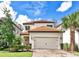 Charming two-story home featuring a tile roof, neutral stucco exterior, and a brick paver driveway at 1147 Wildmeadow Run, Winter Park, FL 32792