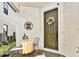 Welcoming front porch featuring decorative sign, seating, and a charming front door with floral wreath at 1147 Wildmeadow Run, Winter Park, FL 32792