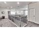 Bright hallway featuring modern lighting, elegant wooden stair rails, and gray carpet flooring at 1147 Wildmeadow Run, Winter Park, FL 32792