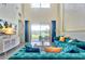 Bright living room with backyard views features an open layout, and comfortable, stylish seating at 1147 Wildmeadow Run, Winter Park, FL 32792