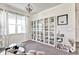 Inviting loft with a large window, modern lighting, display cabinets, and comfortable seating at 1147 Wildmeadow Run, Winter Park, FL 32792