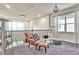 Cozy loft featuring modern lighting, a comfortable chair and foot stool, and gray carpet flooring at 1147 Wildmeadow Run, Winter Park, FL 32792