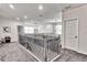 Spacious loft area with carpet flooring, chandelier, neutral walls, and railing overlooking the staircase at 1147 Wildmeadow Run, Winter Park, FL 32792