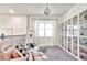 Beautiful loft featuring a cat tower, display cabinets, modern lighting, and comfortable seating at 1147 Wildmeadow Run, Winter Park, FL 32792