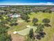 Beautiful aerial view of community featuring a pool, putting green, and a large grassy recreational area at 11868 Thatcher Ave, Orlando, FL 32836