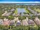 Beautiful aerial view showcasing neighborhood, pond, and lush landscaping at 11868 Thatcher Ave, Orlando, FL 32836