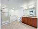 Bright and neutral primary bathroom with a glass enclosed shower and dual sink vanity at 11868 Thatcher Ave, Orlando, FL 32836