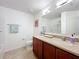 Bright bathroom with tiled floors, neutral countertops, vanity, and shower/tub combo at 11868 Thatcher Ave, Orlando, FL 32836