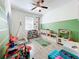 Bright bedroom with wooden floors, a playful ' area, and ample space for activities at 11868 Thatcher Ave, Orlando, FL 32836